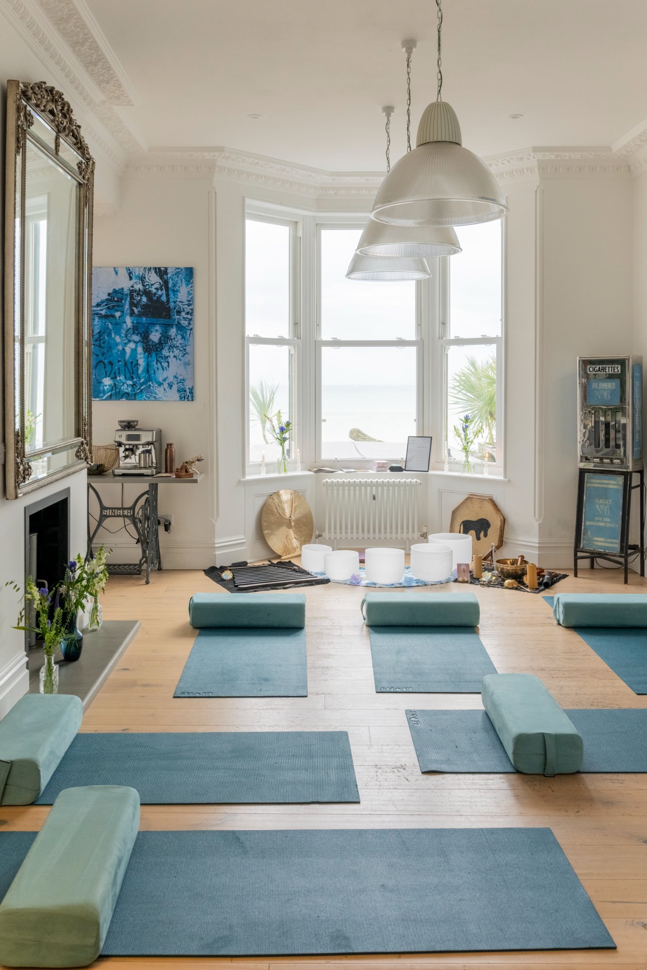 Yoga retreat setup with mats, gong and sea views