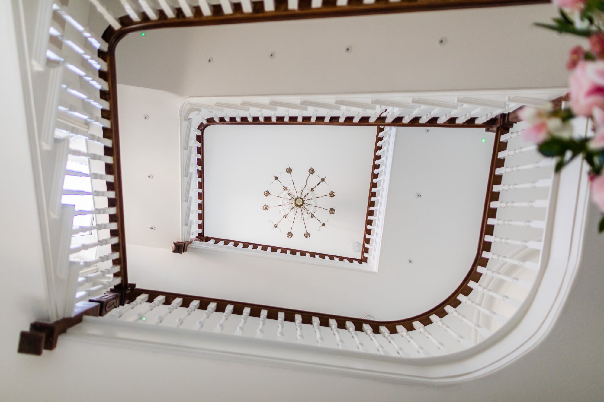 Staircase looking up to chandelier