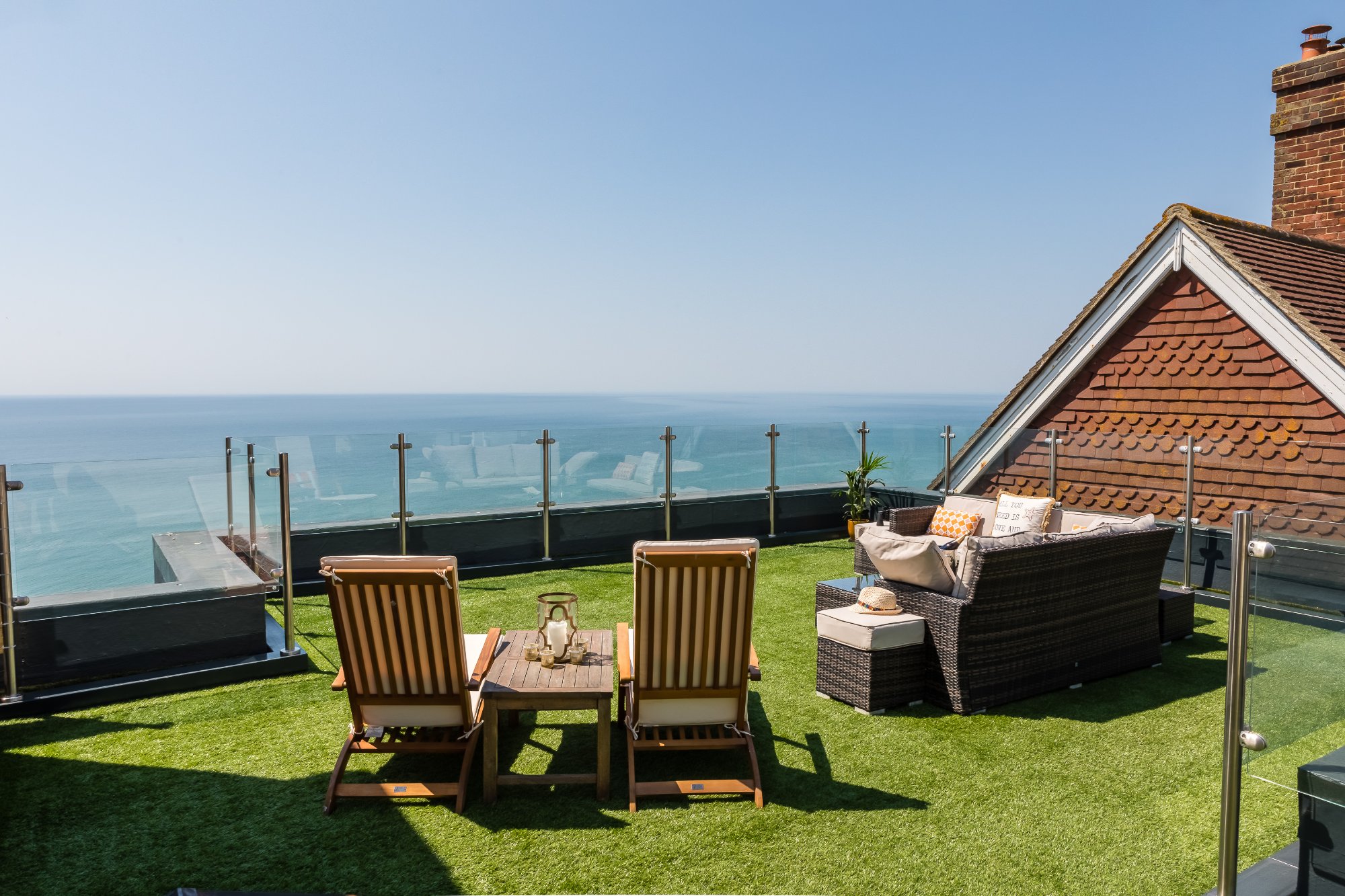 Roof terrace with deck chairs and panoramic sea views