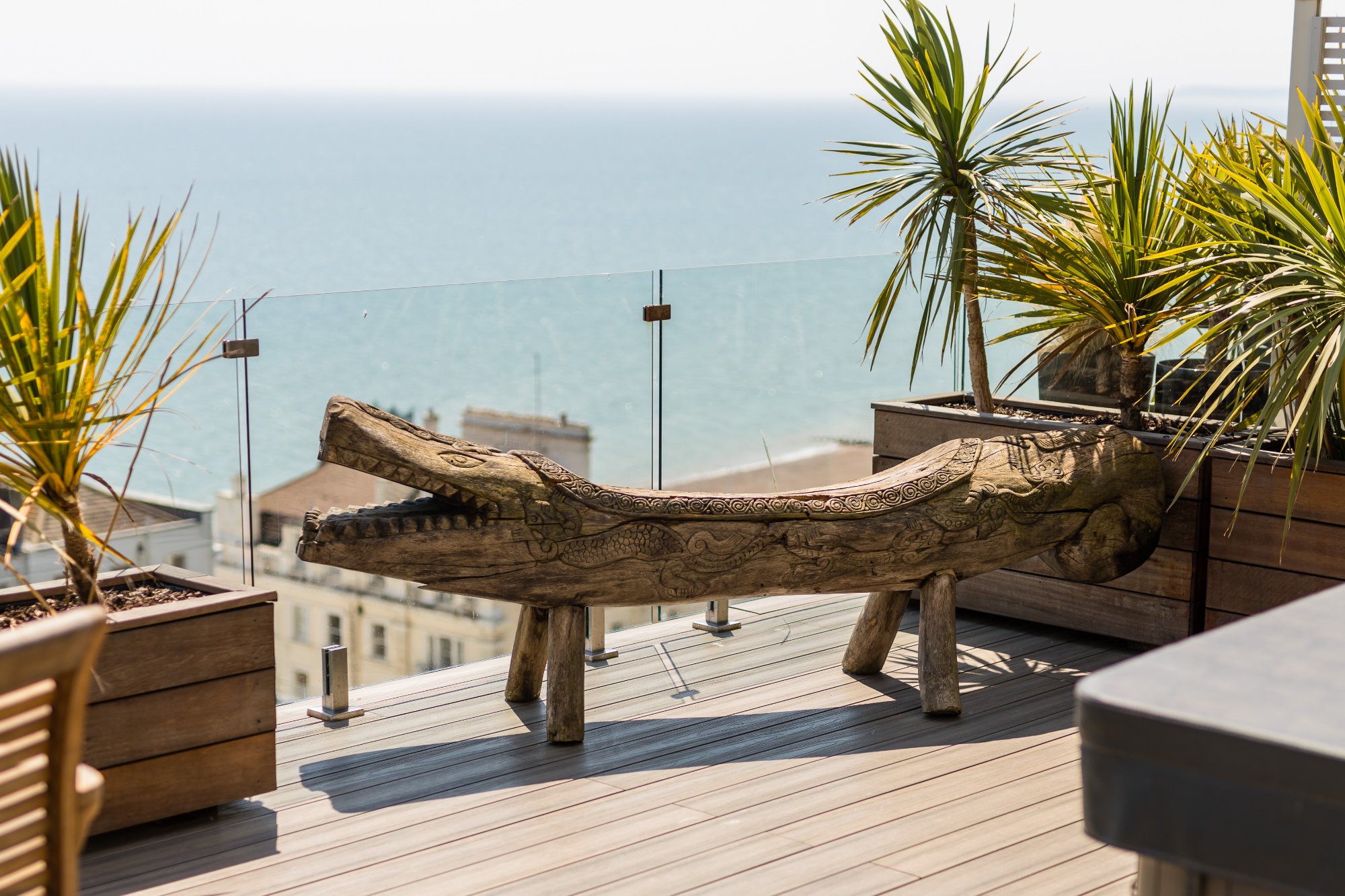 Carved wooden crocodile sculpture on roof terrace
